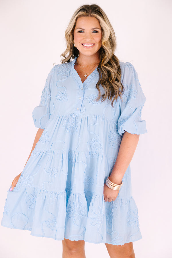 Chic Soul plus size clothing, light blue short puff sleeve tiered baby doll dress with 3 buttons and a v neckline and floral patterned texturing 
