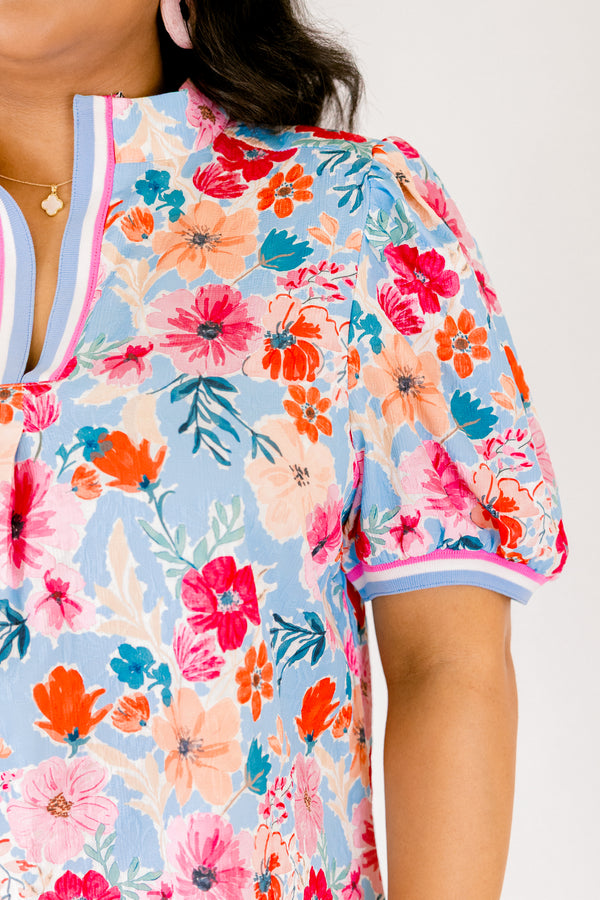 Chic Soul plus size clothing, light blue short sleeve top with pink red and orange floral design through top and blue white and pink stripe hemline along the bottom of the sleeves and bordering the v-neckline