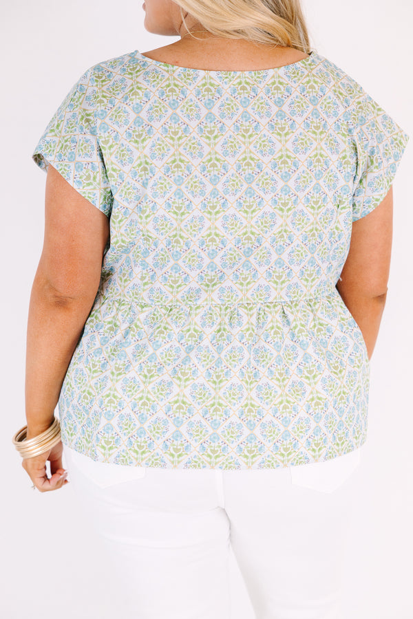 Chic Soul plus size clothing, teal short sleeve top with a floral block pattern and three blue bows going down the center of the bust 