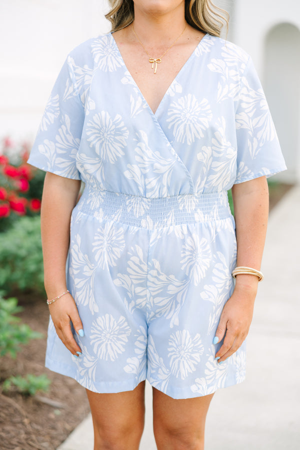 Plus Size baby blue floral romper with a surplice neckline, short sleeves, and elastic waist.
