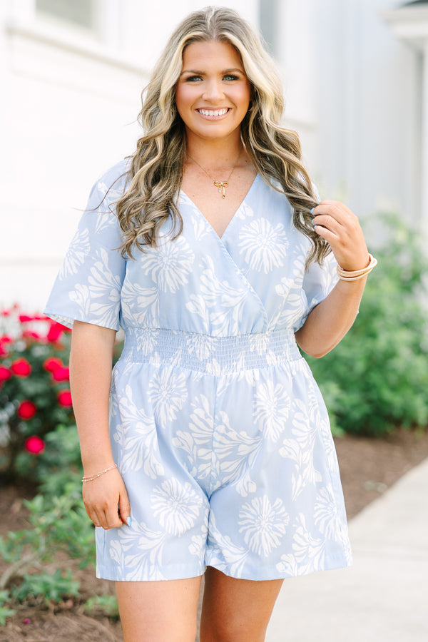 Plus Size baby blue floral romper with a surplice neckline, short sleeves, and elastic waist.