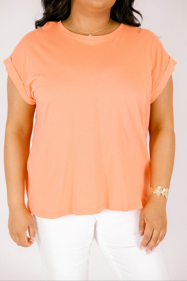 coral tee with cuffed short sleeves and a round neckline