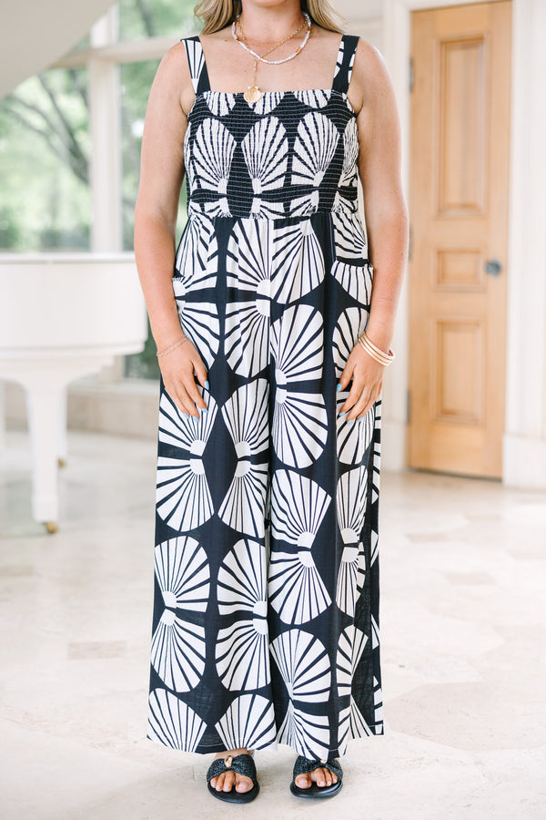 Chic Soul Plus Size Clothing, Black wide-leg jumpsuit with a white shell pattern, smocked bodice, and thin straps.