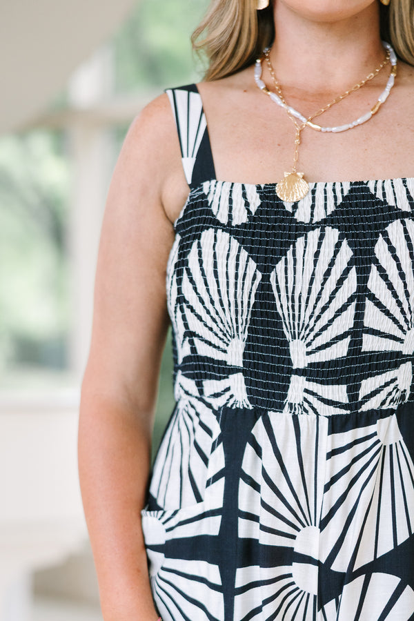 Chic Soul Plus Size Clothing, Black wide-leg jumpsuit with a white shell pattern, smocked bodice, and thin straps.