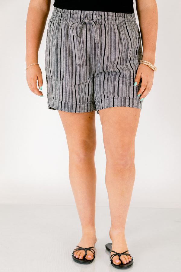 Chic Soul plus size clothing, gray striped shorts with pockets on the front of the shirts ad a draw string waistband that has a bow that ties in the center of the shorts 