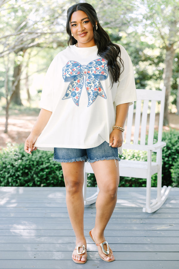 Chic Soul plus size clothing, ivory short sleeve graphic tee with a blue bow graphic in the center and a red and blue floral pattern filling the bow 