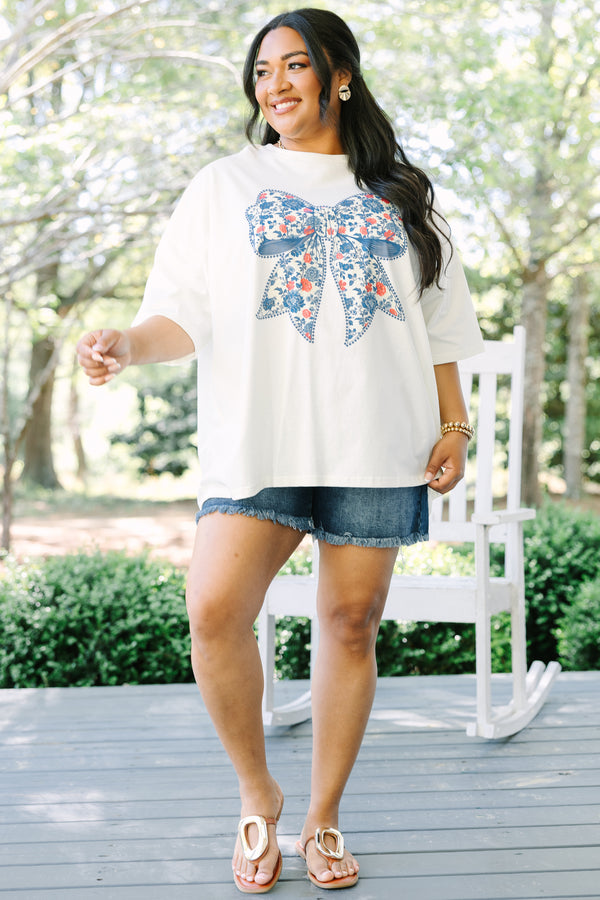 Chic Soul plus size clothing, ivory short sleeve graphic tee with a blue bow graphic in the center and a red and blue floral pattern filling the bow 