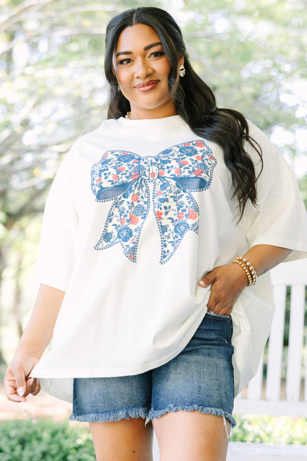 Chic Soul plus size clothing, ivory short sleeve graphic tee with a blue bow graphic in the center and a red and blue floral pattern filling the bow 