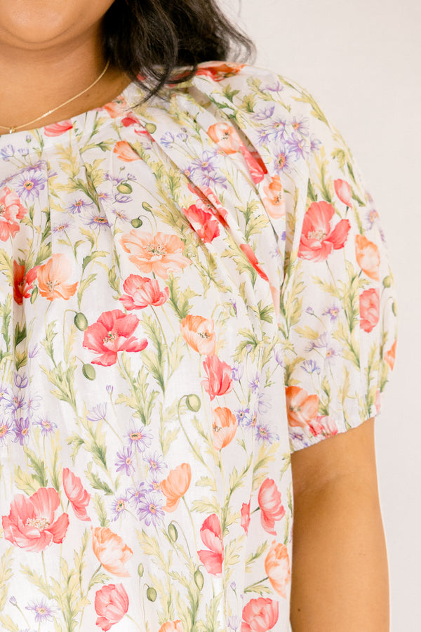 Chic Soul plus size clothing, white top with short bubble sleeves that has a green floral pattern throughout 