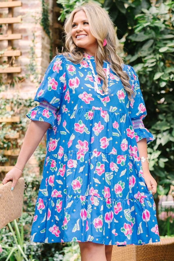 Chic Soul plus size clothing, cobalt tiered knee length dress with half sleeves that have a ruffle flare at the end of each sleeve as well as a pink floral pattern throughout and scalloped detailing on the v-neckline 