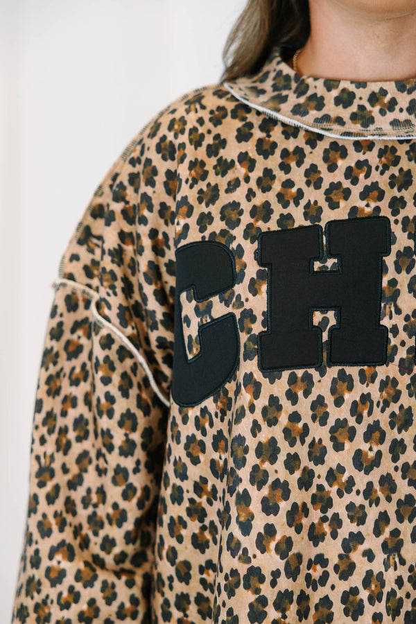 Plus Size brown leopard print mock neck pullover with black CHIC lettering and long sleeves.