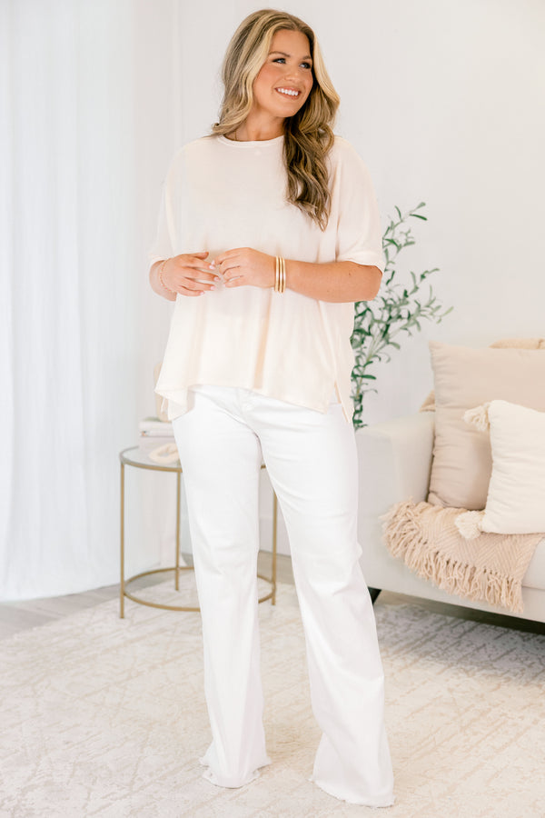 Chic Soul plus size clothing, white flared jeans with front pockets and fringe details at the bottom of each pant leg 