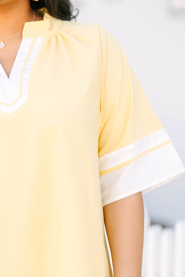 Chic Soul plus size clothing, yellow short sleeve straight cut dress with white trim along the hem, neckline, and sleeves