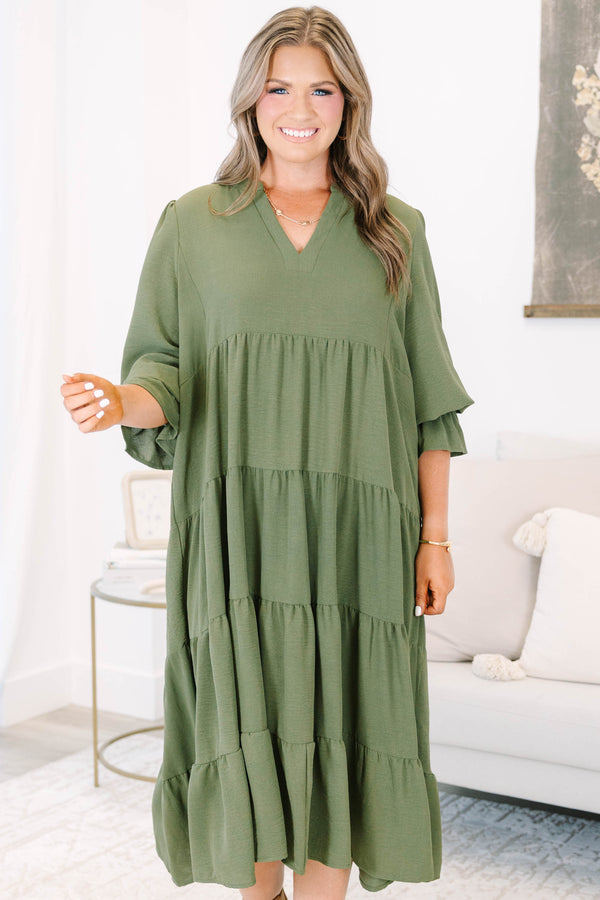 Plus size forest green tiered midi dress with a flowy fit, V-neckline, and ruffled sleeves.