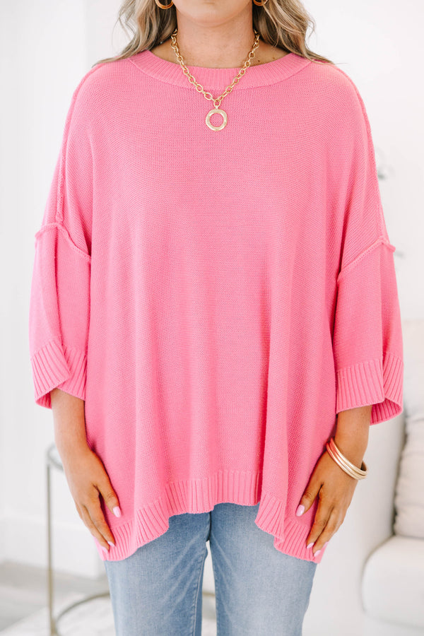 Bright pink sweater with a relaxed drop shoulder knit and exposed seams.