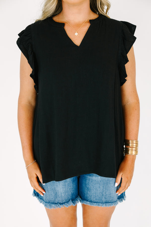 Plus Size black v-neck top with ruffled cap sleeves and a relaxed fit.