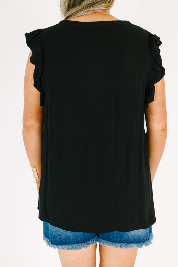 Plus Size black v-neck top with ruffled cap sleeves and a relaxed fit.