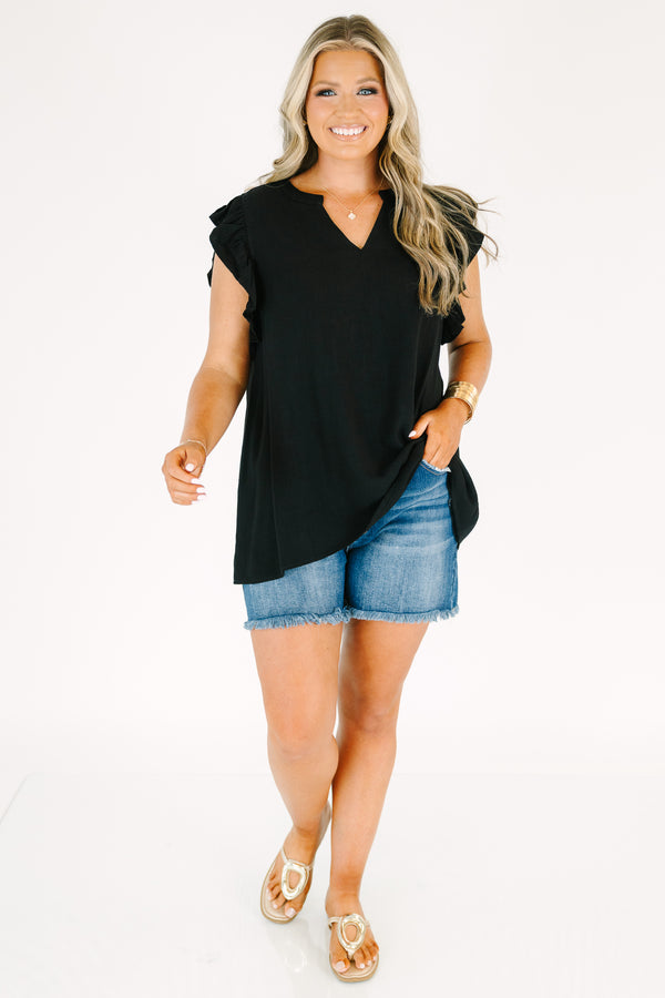 Plus Size black v-neck top with ruffled cap sleeves and a relaxed fit.