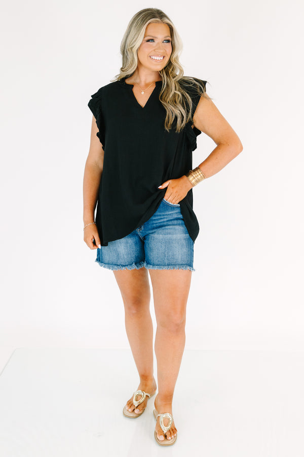 Plus Size black v-neck top with ruffled cap sleeves and a relaxed fit.