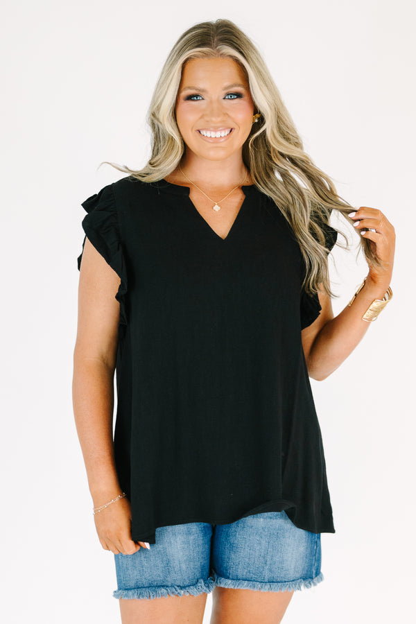 Plus Size black v-neck top with ruffled cap sleeves and a relaxed fit.