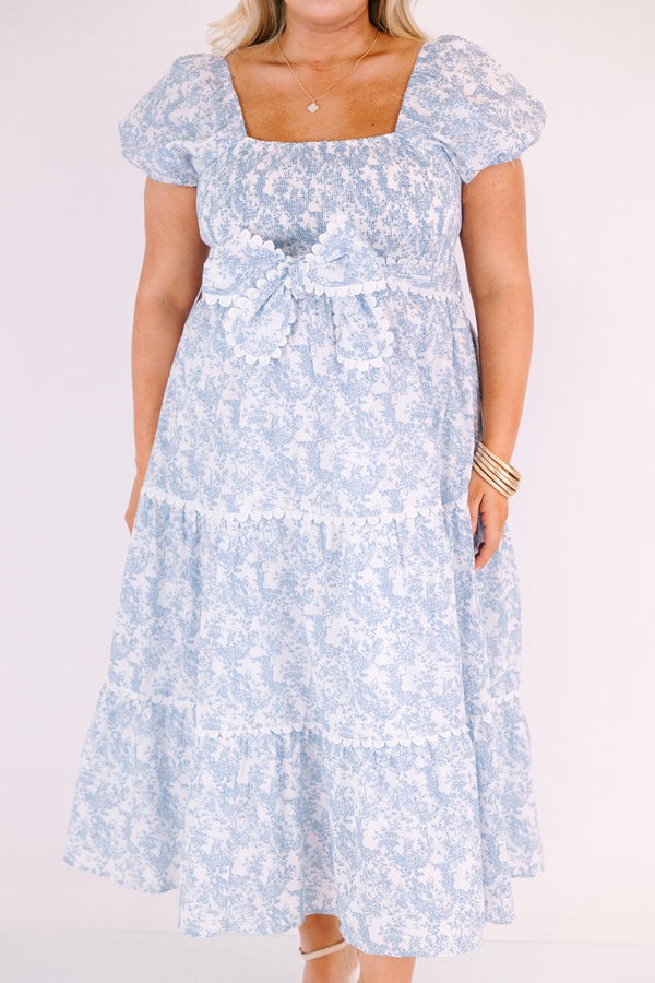 Chic Soul plus size clothing, blue and white toile print short puff sleeve square neck tiered maxi dress with bow tying at the waist and white scalloped trim around each tier and along the slides of the bow 
