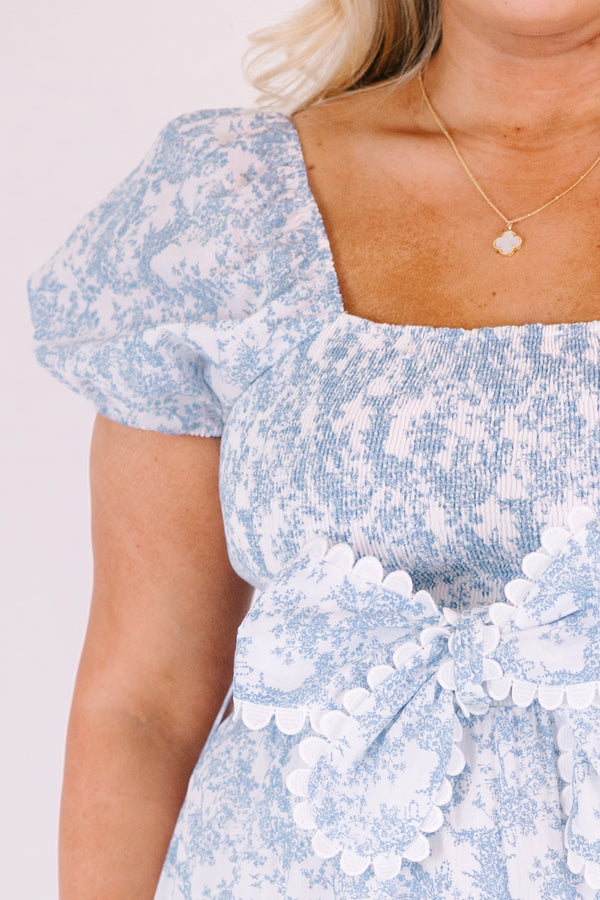 Chic Soul plus size clothing, blue and white toile print short puff sleeve square neck tiered maxi dress with bow tying at the waist and white scalloped trim around each tier and along the slides of the bow 
