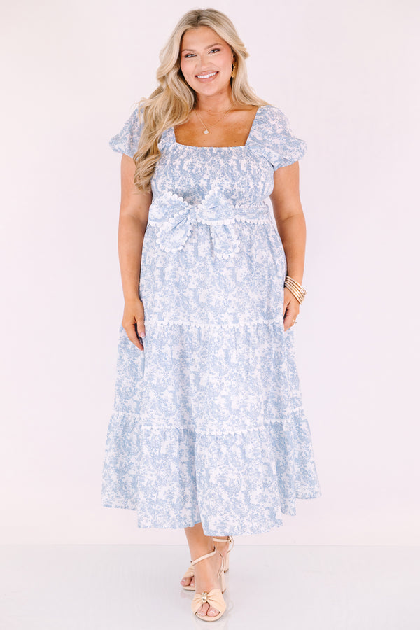 Chic Soul plus size clothing, blue and white toile print short puff sleeve square neck tiered maxi dress with bow tying at the waist and white scalloped trim around each tier and along the slides of the bow 

