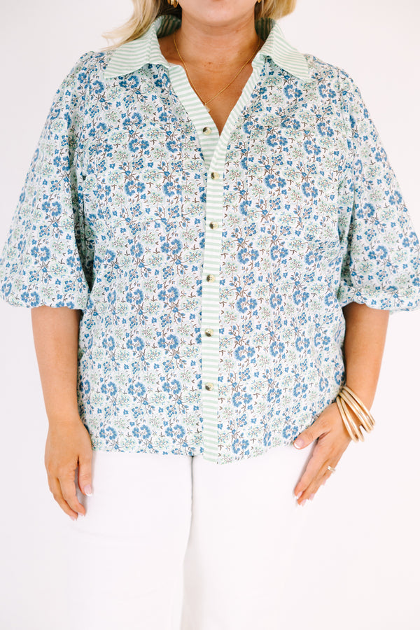 Chic Soul plus size clothing, blue button-up top with bubble sleeves and a floral pattern throughout as well as a green stripe detail going down the center of the shirt and on the collar 