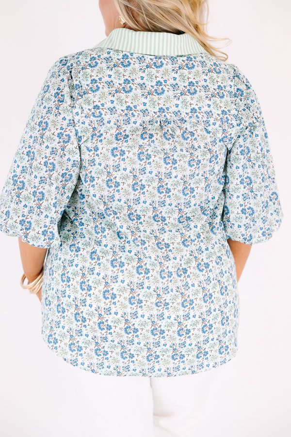 Chic Soul plus size clothing, blue button-up top with bubble sleeves and a floral pattern throughout as well as a green stripe detail going down the center of the shirt and on the collar 
