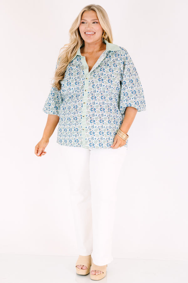 Chic Soul plus size clothing, blue button-up top with bubble sleeves and a floral pattern throughout as well as a green stripe detail going down the center of the shirt and on the collar 