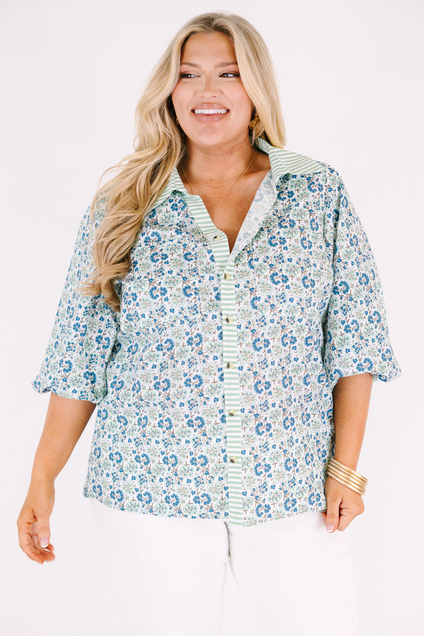 Chic Soul plus size clothing, blue button-up top with bubble sleeves and a floral pattern throughout as well as a green stripe detail going down the center of the shirt and on the collar 