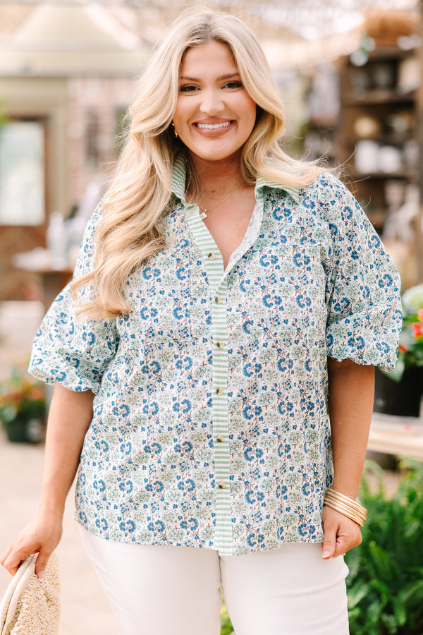 Chic Soul plus size clothing, blue button-up top with bubble sleeves and a floral pattern throughout as well as a green stripe detail going down the center of the shirt and on the collar 