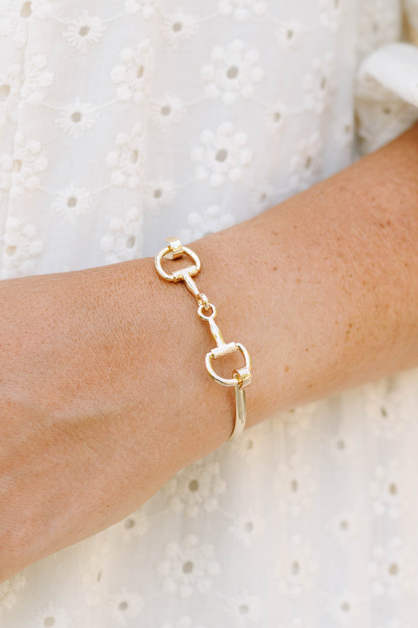 Plus Size gold horse bit style bangle bracelet worn with a white eyelet lace top.