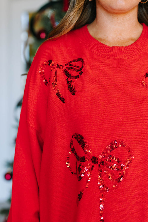 Plus Size red oversized crewneck sweater with sequined bow designs and long sleeves.