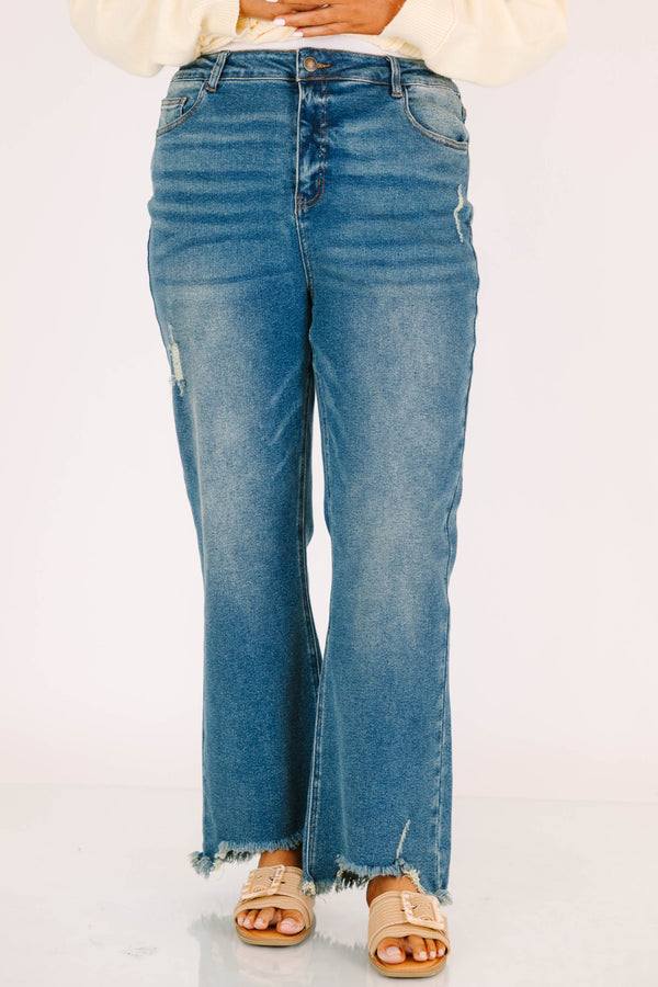 Plus Size vintage wash wide leg jeans with a high waist, distressed details, and frayed hems.