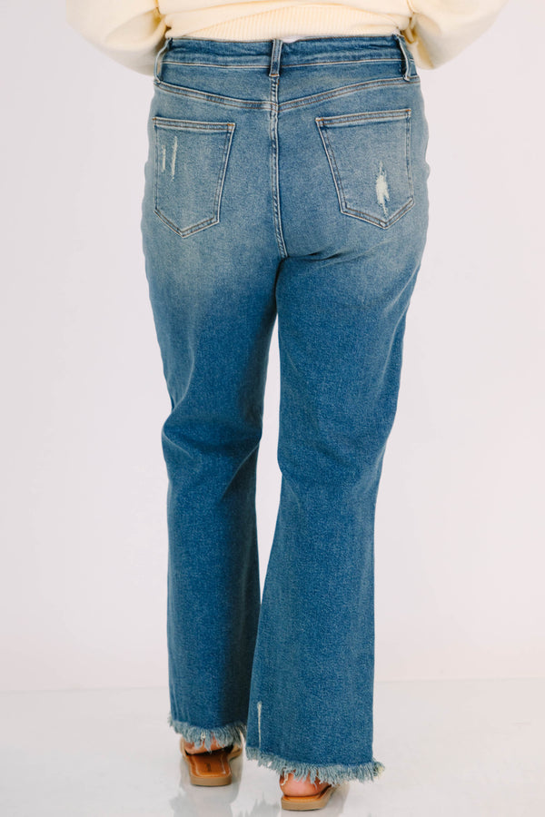 Plus Size vintage wash wide leg jeans with a high waist, distressed details, and frayed hems.
