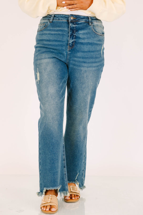 Plus Size vintage wash wide leg jeans with a high waist, distressed details, and frayed hems.