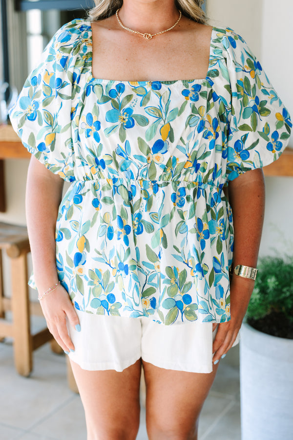 Plus Size green and blue floral babydoll top with a square neckline and puff sleeves.