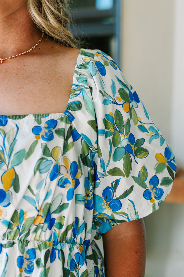 Plus Size green and blue floral babydoll top with a square neckline and puff sleeves.
