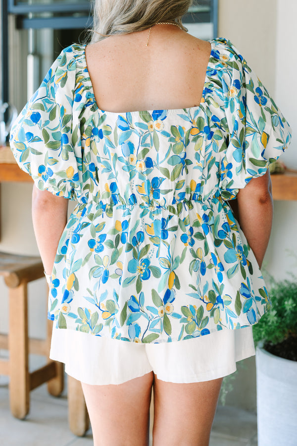 Plus Size green and blue floral babydoll top with a square neckline and puff sleeves.