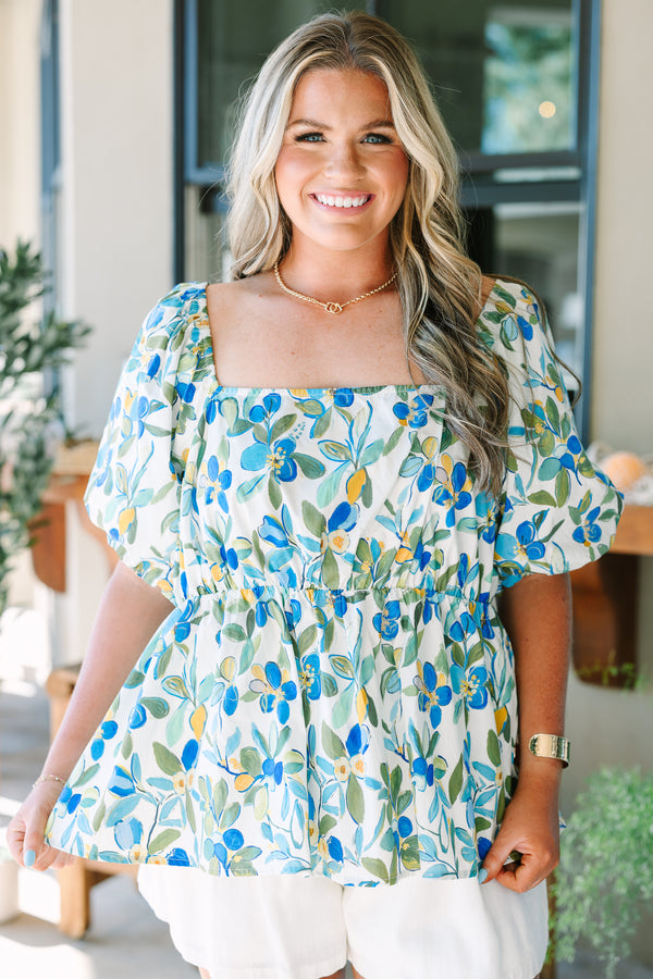Plus Size green and blue floral babydoll top with a square neckline and puff sleeves.