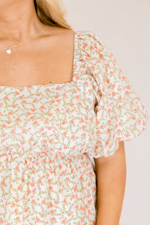 Chic Soul plus size clothing, white top with a square neckline and bubble sleeves as well as a orange floral pattern throughout 