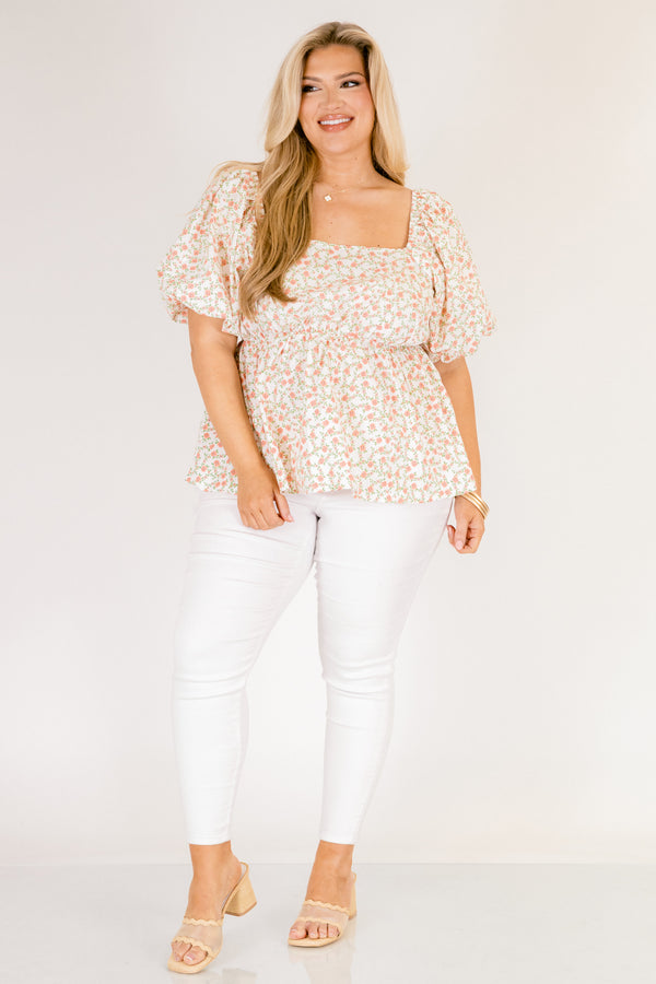Chic Soul plus size clothing, white top with a square neckline and bubble sleeves as well as a orange floral pattern throughout 