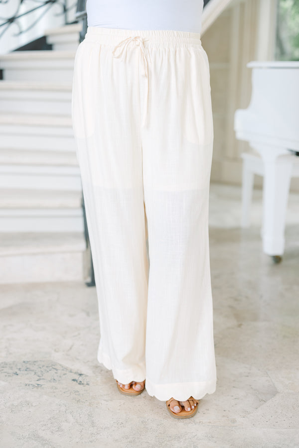 Plus Size white linen wide-leg pants with an elastic drawstring waist and scalloped hem.