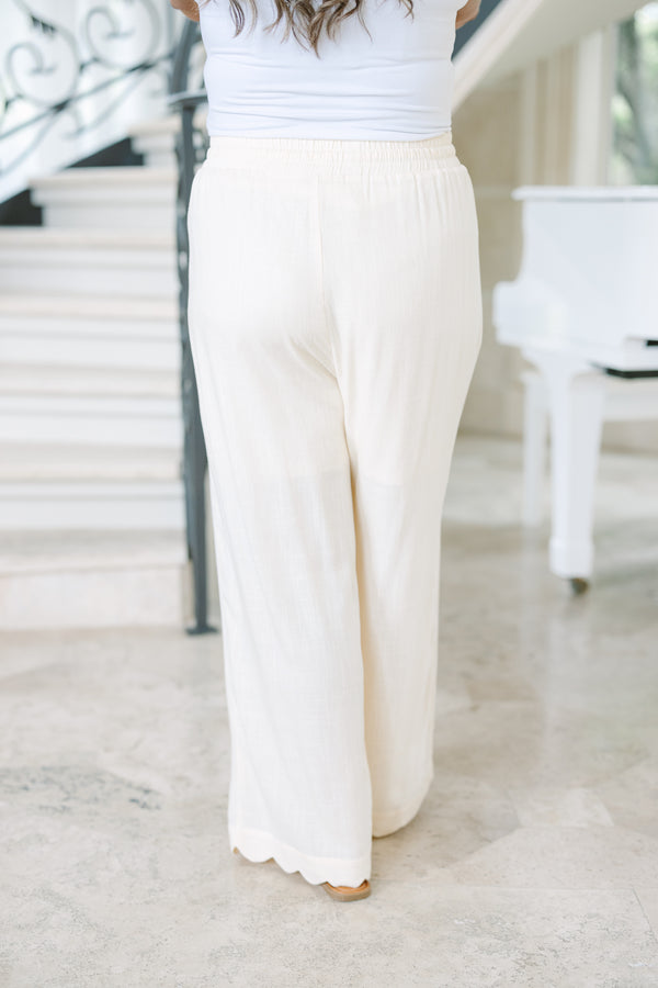 Plus Size white linen wide-leg pants with an elastic drawstring waist and scalloped hem.