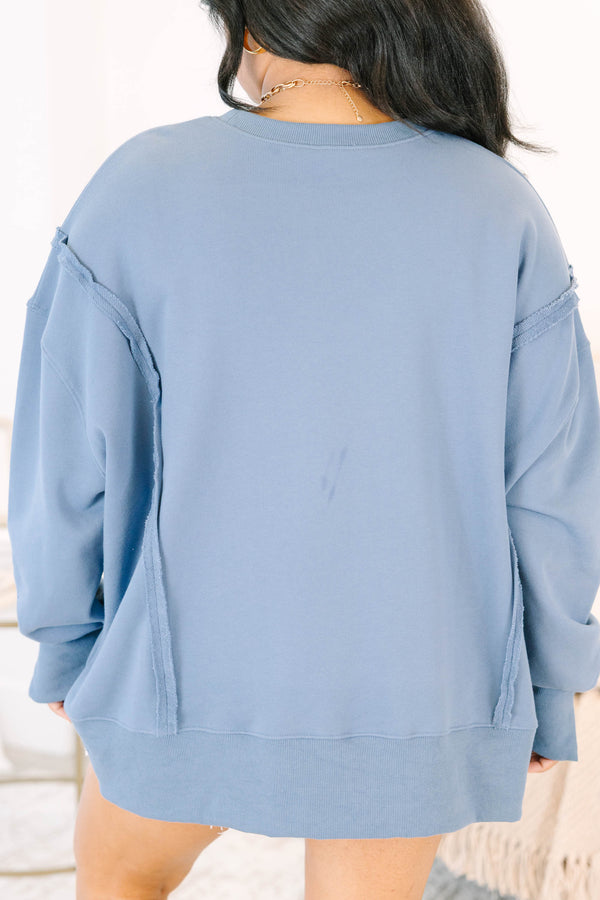 Plus Size denim blue crewneck sweatshirt with a large red and blue star-patterned bow graphic.
