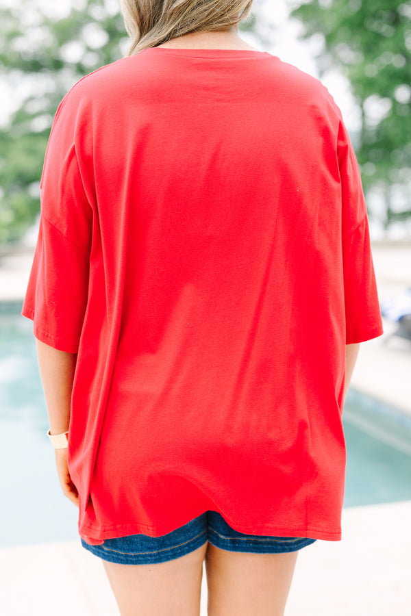 Back view of a red, oversized boyfriend-style t-shirt with short sleeves and a crew neckline.