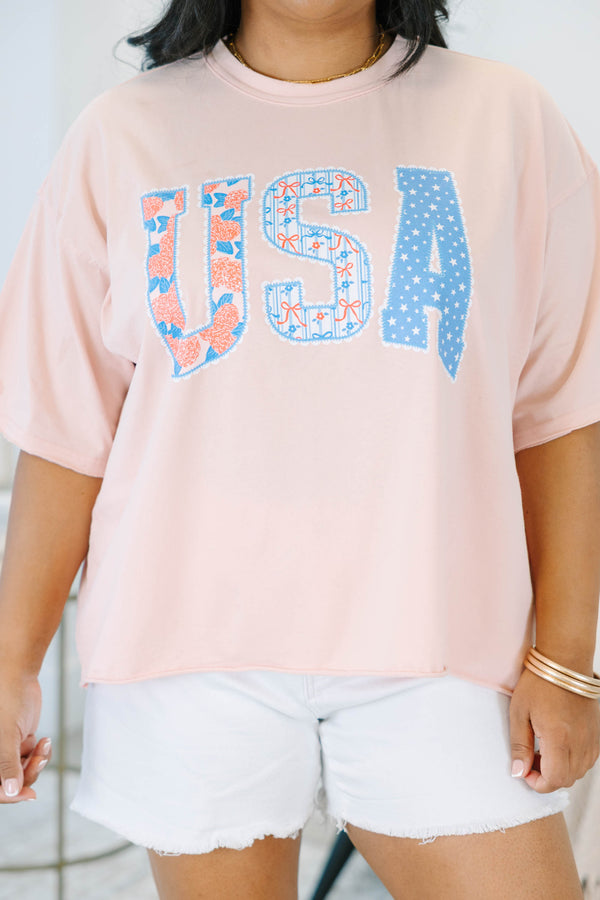 Plus Size blush pink vintage wash tee with USA floral and star patchwork lettering.