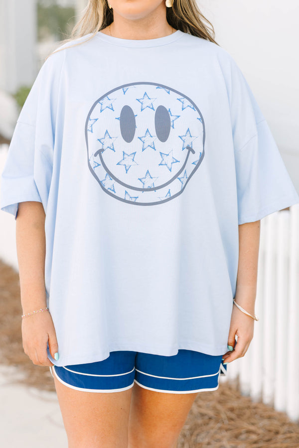 Chic Soul plus size clothing, light blue short sleeve boyfriend tee with light grey smiley face on the front of the tee with darker blue star outlines inside of the smiley face