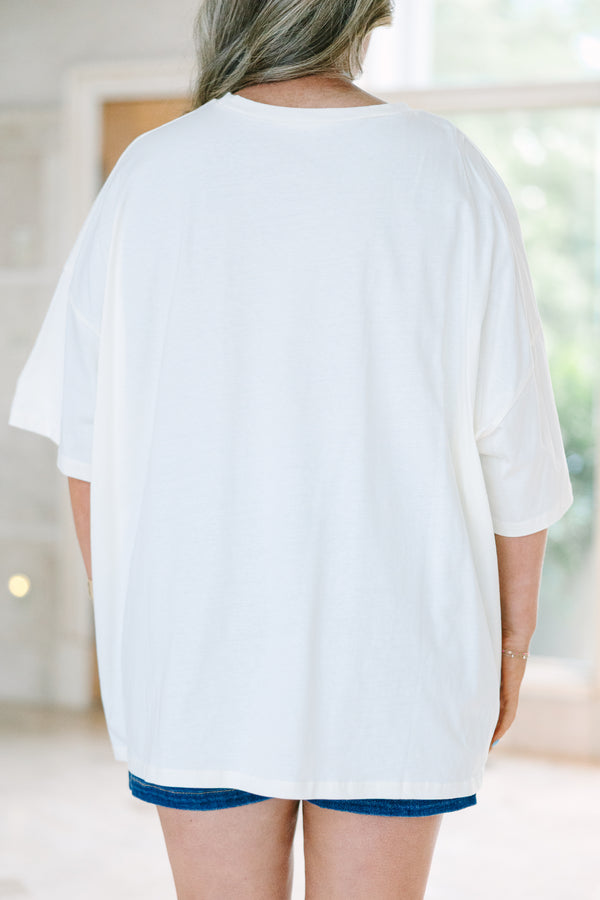 Plus Size ivory boyfriend tee with a blue and yellow staycation stamp graphic and denim shorts.